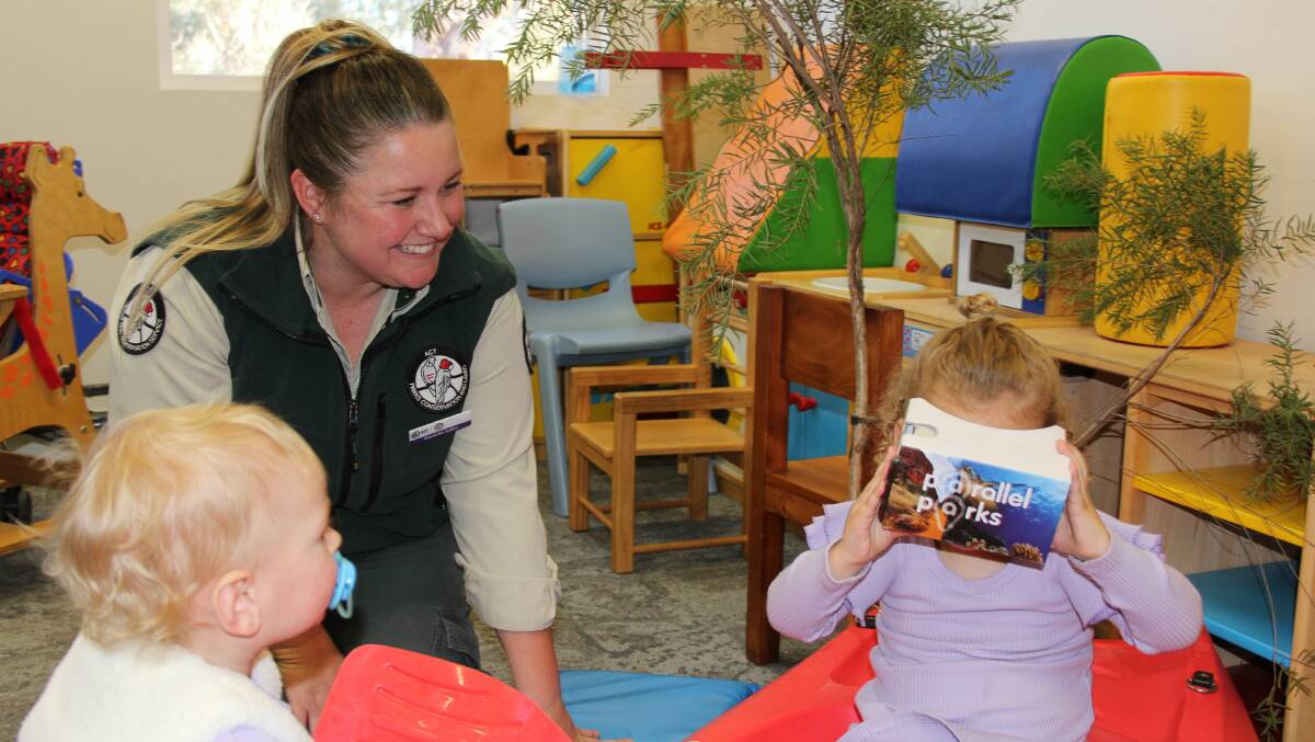 Ranger Danielle Sykes helps Matilda Rogers, 1, and Charlotte Rogers, 2, with ParksVR. Picture: Supplied