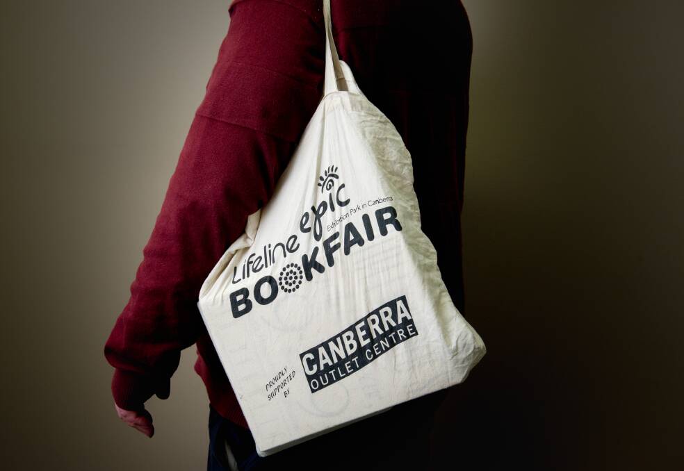 Carrying a bag of goodies from the Lifeline Book Fair. Picture: Elesa Kurtz