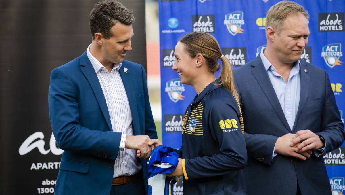 Maddie Penna receives her Meteors shirt from Cricket ACT chief James Allsopp. Picture: Jamila Toderas