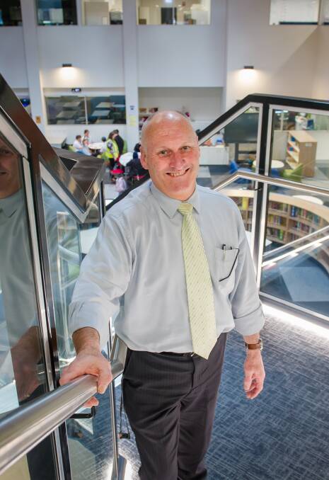 Belconnen High School principal David McCarthy on the stairs above the school's learning commons. Picture: Elesa Kurtz