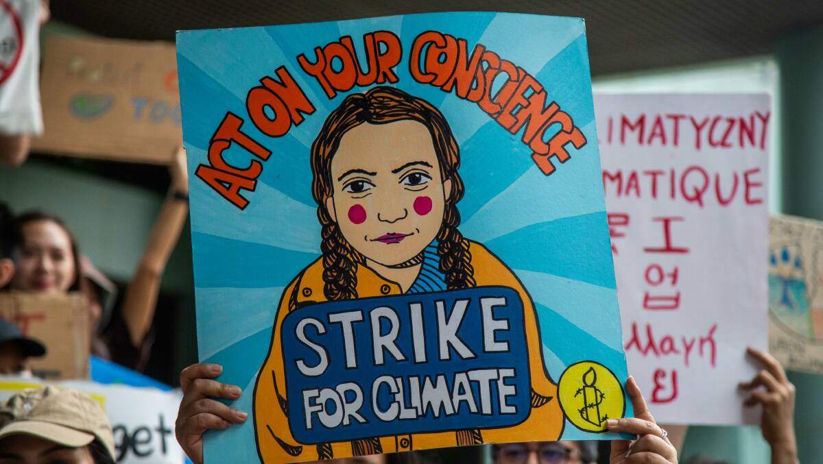 Thai climate protesters rally behind an image of Greta Thunberg on September 20. The 16-year-old has a global following. Picture: Getty Images