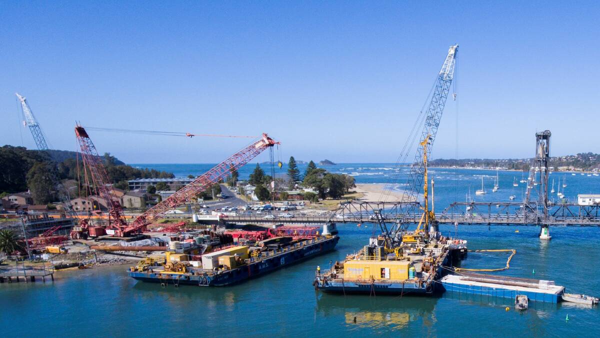 Barge-mounted cranes are used to lift the new Batemans Bay bridge sections into place. The $274 million project will take 3 years to complete. Picture: Supplied