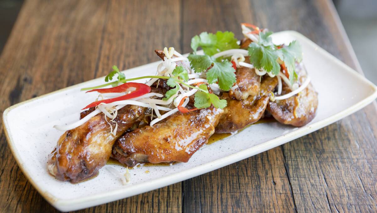 Chicken wings with sticky chilli caramel and Asian herbs. Picture: Jamila Toderas