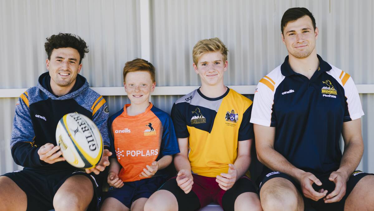 Brumbies Tom Banks and Nick Frost with Bede Fogarty 11, Dylan Bretton 13 at the AIS Boys Junior Talent ID Camp on Wednesday. Picture: Jamila Toderas