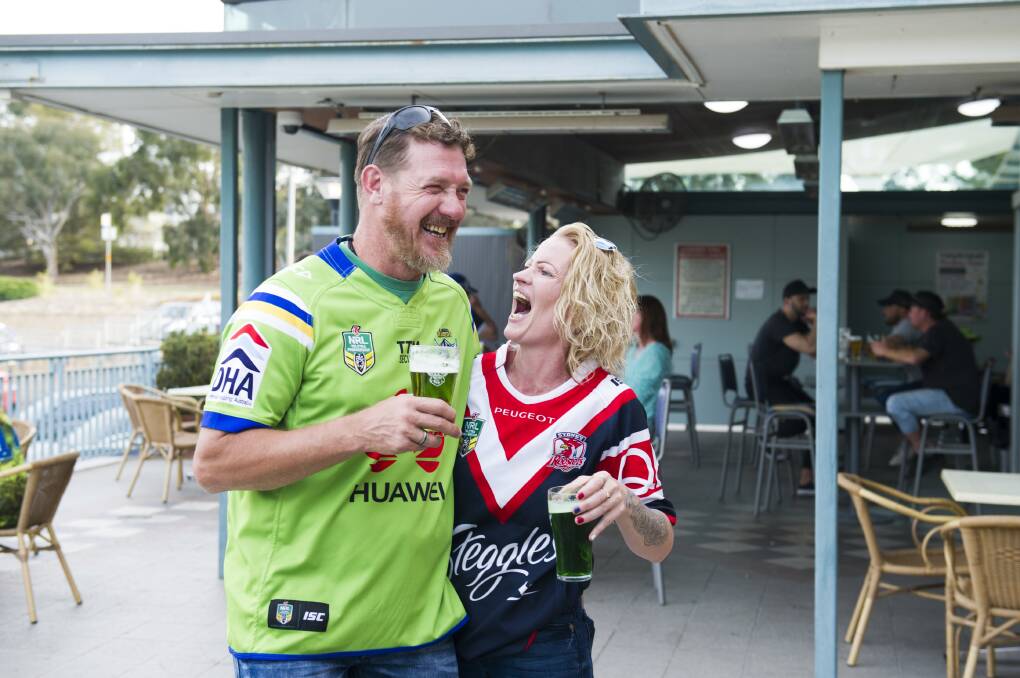 Raiders fan Luke Burns with his partner Sammie Adams, who supports the Roosters. Picture: Dion Georgopoulos