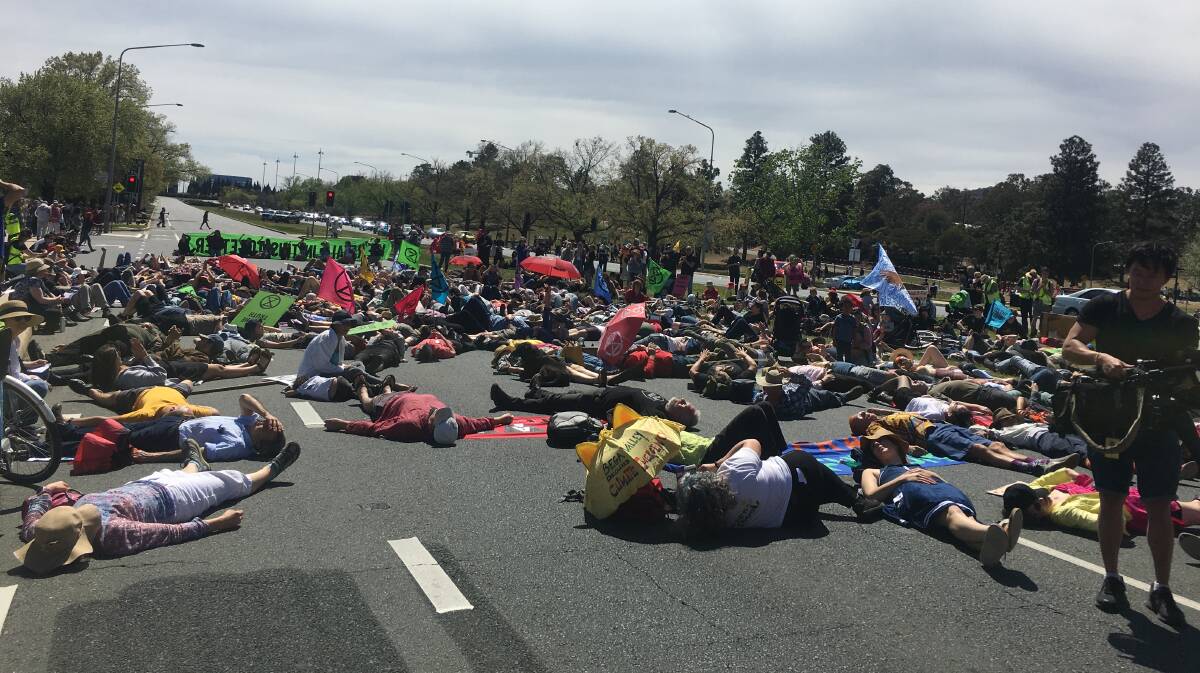 Extinction Rebellion protesters take over Commonwealth Avenue in protest of climate change inaction. Picture: Peter Brewer