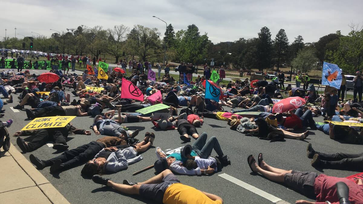 Protesters take over Commonwealth Avenue in a staged "die-in" in protest of climate change inaction. Picture: Peter Brewer