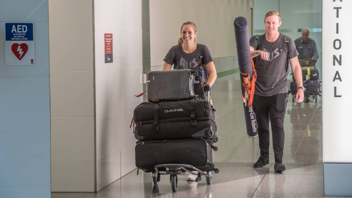Kelsey Lee and Mike Barber at Canberra Airport after the 2019 Doha World Championships. Picture: Karleen Minney