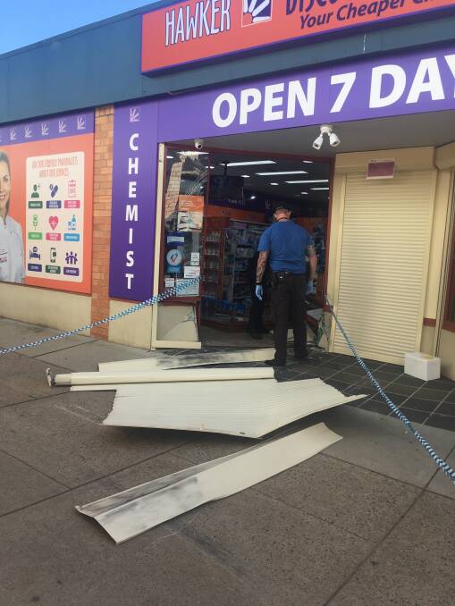 Police at the scene of an overnight ram raid at a chemist in Hawker, which police believe is linked to another incident in Curtin. Picture: Carolyn Kidd