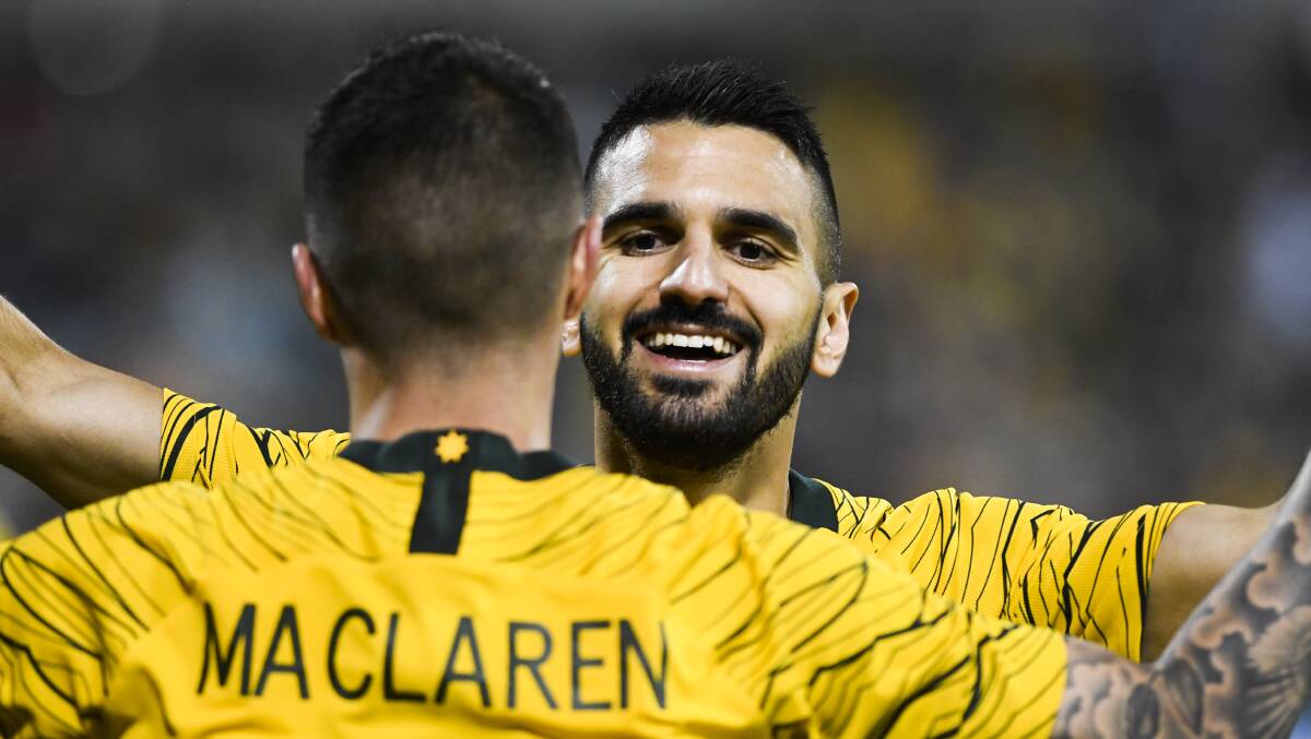 Aziz Behich celebrates with Jamie Maclaren after the striker completed his hat-trick. Picture: Dion Georgopoulos