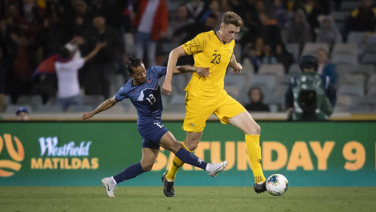 Nepal's Tej Tamang and Australia's Harry Souttar. Picture: Sitthixay Ditthavong