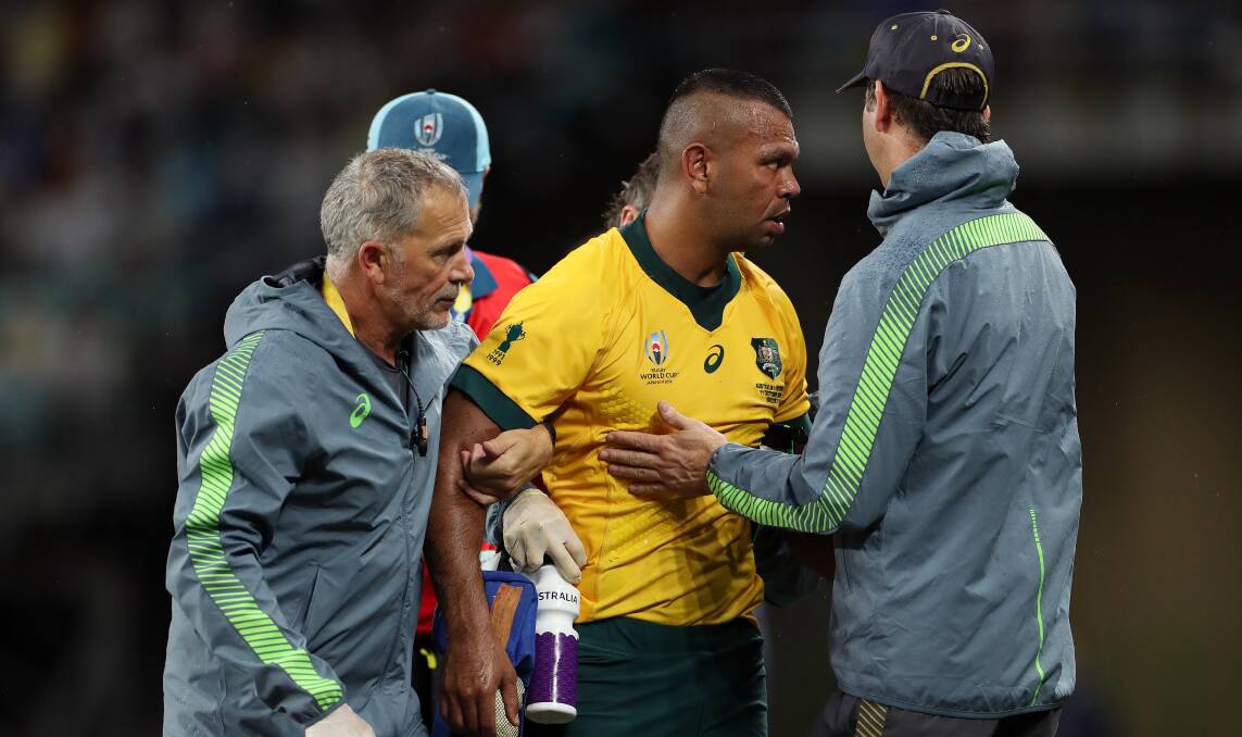 Kurtley Beale of Australia is assisted off the pitch by medical staff on Friday. Picture: Getty Images
