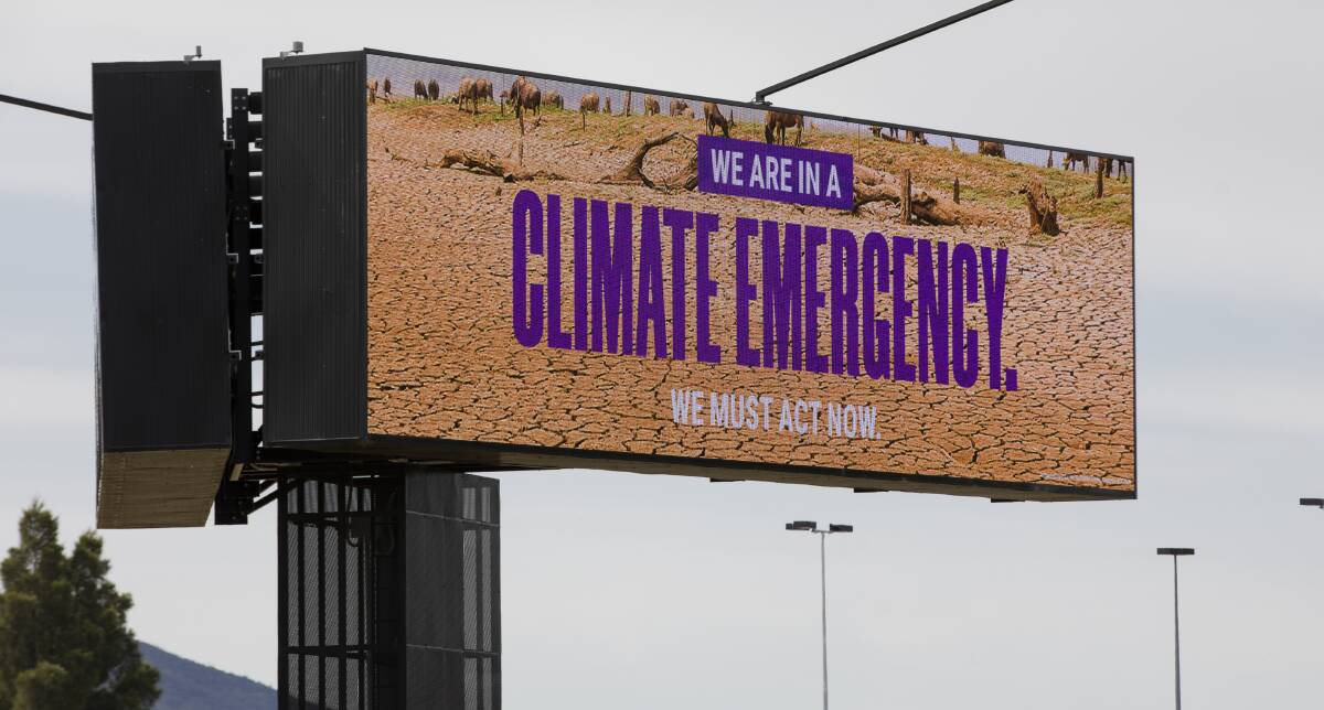The Greens' climate emergency billboard at Canberra Airport. Picture: Jamila Toderas