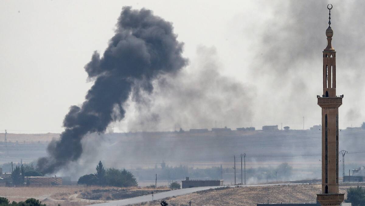 Smoke rises over the Syrian town of Tel Abyad. Picture: Getty Images