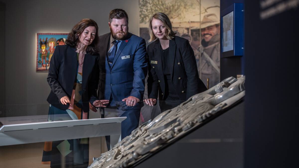 Lead curator Margaret Farmer, military historian David Sutton and senior curator Melissa Cadden looking over the War Memorial's new exhibition. Picture: Karleen Minney.