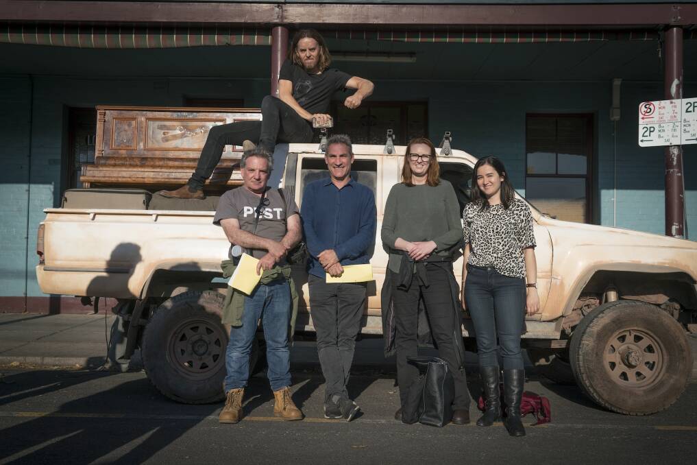 Niki Aken (far right) with Tim Minchin (on top of the ute) on the set of the new Foxtel drama Upright.