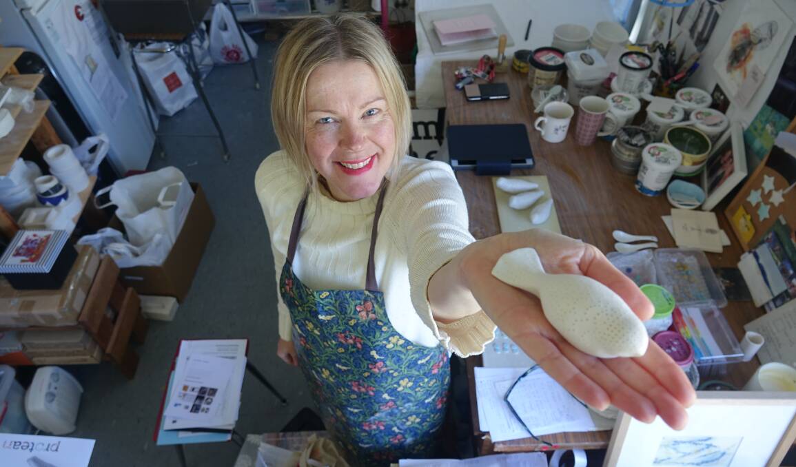 Ceramicist Anne Masters and the porcelain bird she is selling to raise money for drought relief. Picture: Steve Evans