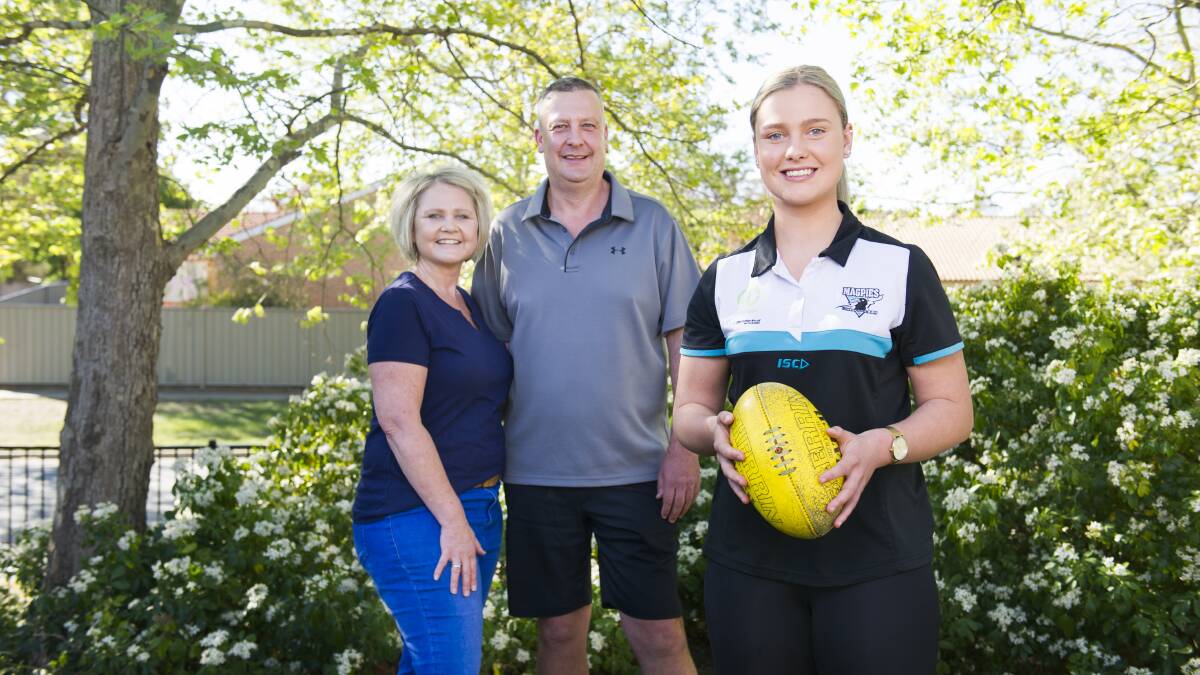 Canberra-based AFLW draft prospect Maggie Gorham, and parents Brett and Donna at their home in Palmerston. Picture: Dion Georgopoulos