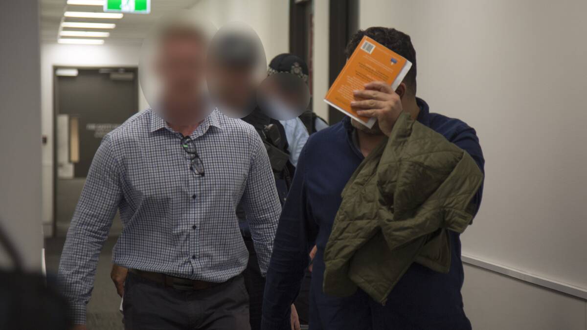 Maythem Radhi is taken into custody at Brisbane Airport. Picture: AFP