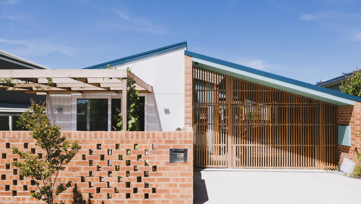 At the front of the award-winning sustainable home faces north, so the alfresco area is there, shaded in summer by fast-growing ornamental grapes which drop their leaves in winter to allow the sun in. Even the garage door is timber-battened, rather than solid, to allow the light to filter through. Picture: Jamila Toderas