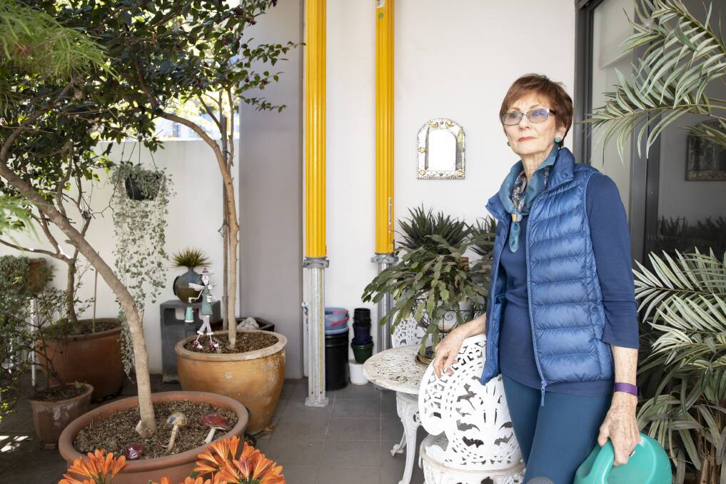 Kingston Place apartment owner Jill Davies with two of the three props installed in her courtyard. Picture: Sitthixay Ditthavong