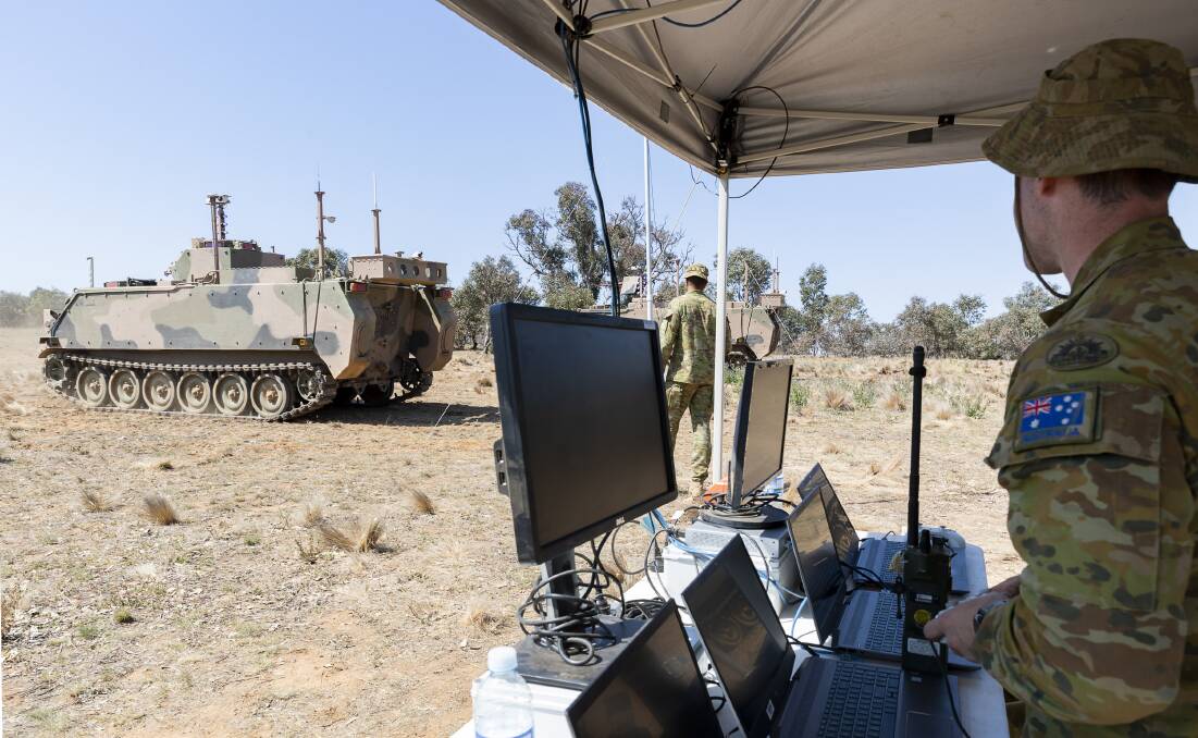 Australian Army soldier Trooper Chris Jack remotely controls an autonomous M113 AS4 optionally crewed combat vehicle at the Majura Training Area, Canberra. Picture: Department of Defence