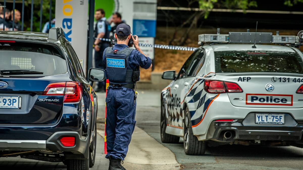 ACT policing crime scene investigators examine a car on the grounds of Manuka Oval. Picture: Karleen Minney