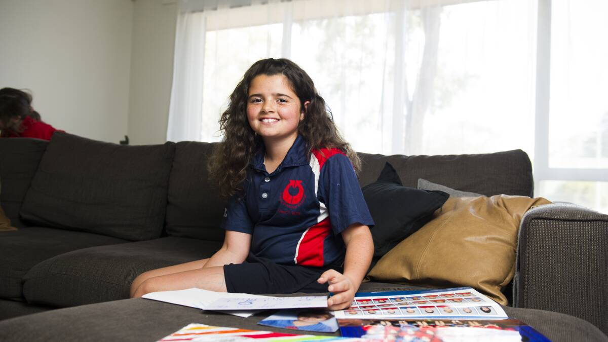Tiarni Mara looking back at her old school photos from Curtin Primary School. Picture: Dion Georgopoulos