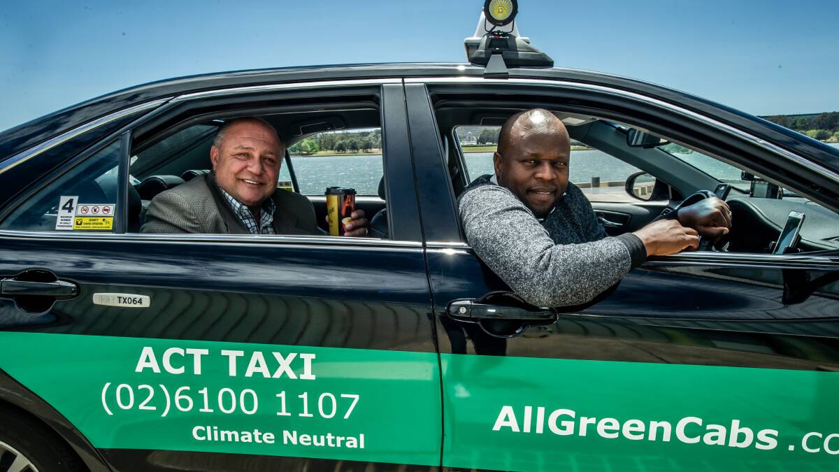 AllGreenCabs has been launched as a new taxi service in Canberra. Managing director Petar Johnson (left) with drivers manager and operator Shegun Odusote. Picture: Karleen Minney
