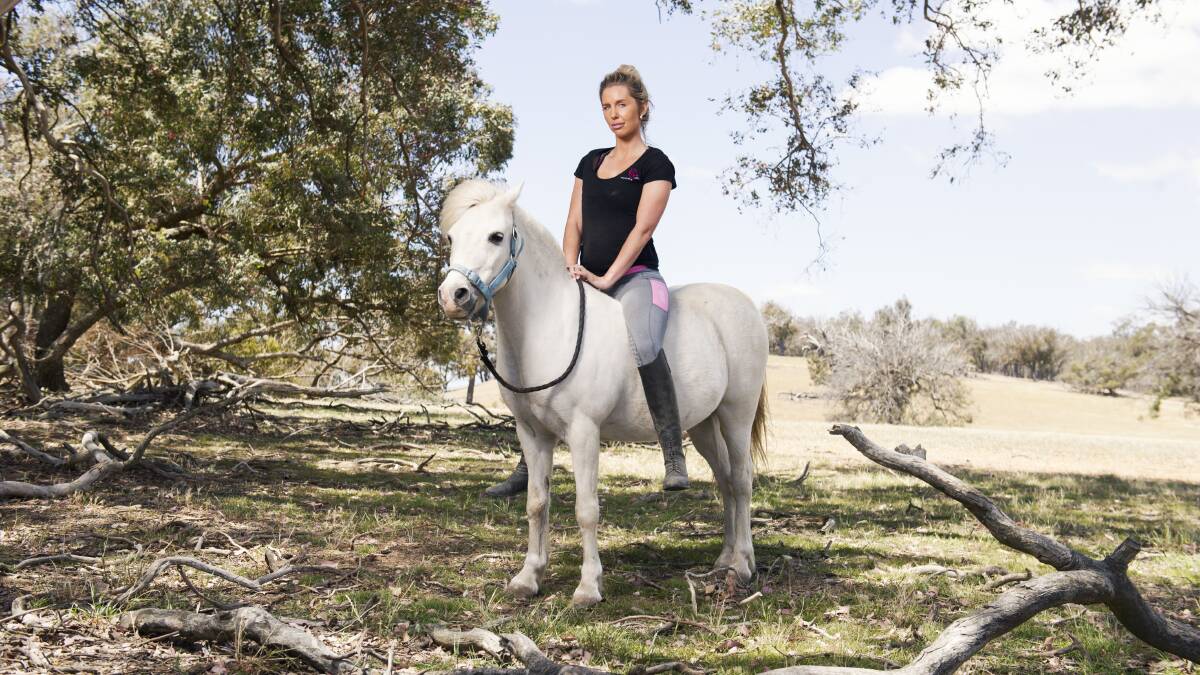 Chynna Marston, with Fred, has 40 horses on her property just outside Yass. Picture: Dion Georgopoulos