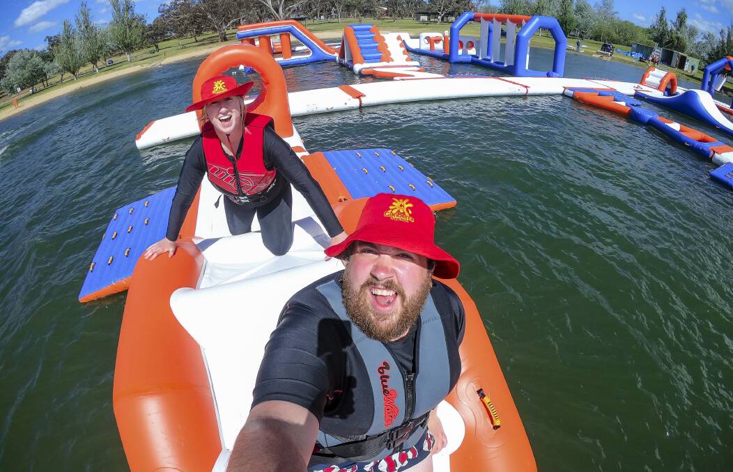 Canberra Aqua Park park attendants Natalie Graham and Declan Moore test the park ahead of its public launch on Saturday. Picture: Sitthixay Ditthavong