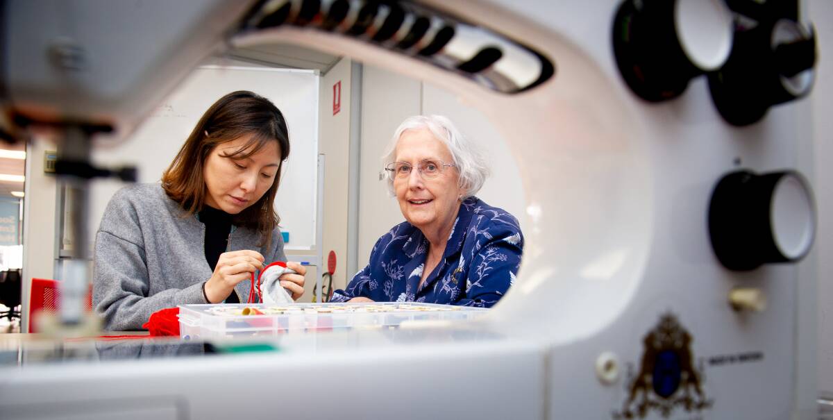 Monica Andrew, right, helps Jee Lee at the University of Canberra's weekly repair cafe. Picture: Elesa Kurtz