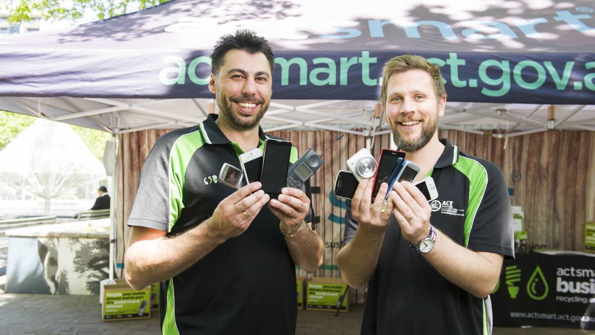 Lee Rupil and Hugo Temby from Actsmart with some of the old mobile phones brought in to be recycled for a world record attempt for most recycled phones in a day. Picture: Dion Georgopoulos