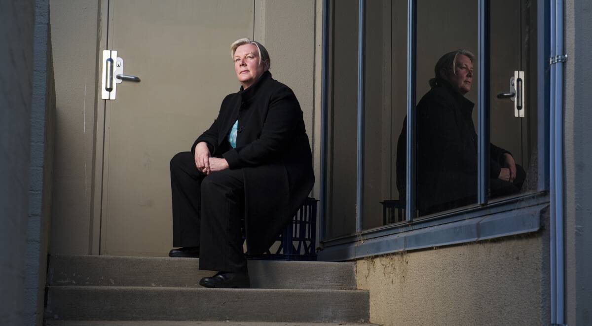 Catholic Care CEO Anne Kirwan sits at a staircase outside the Catholic Care offices where she says more people now sleep rough each night. Picture: Dion Georgopoulos