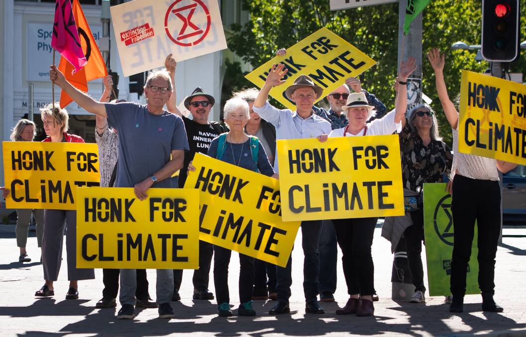 Older members of climate activist group Extinction Rebellion, front from left, Scott Umbers, Margaret Clough, John Wurcker and Julie Hill say they're not hardened activists but have joined out of frustration with a lack of action on climate change. Picture: Elesa Kurtz