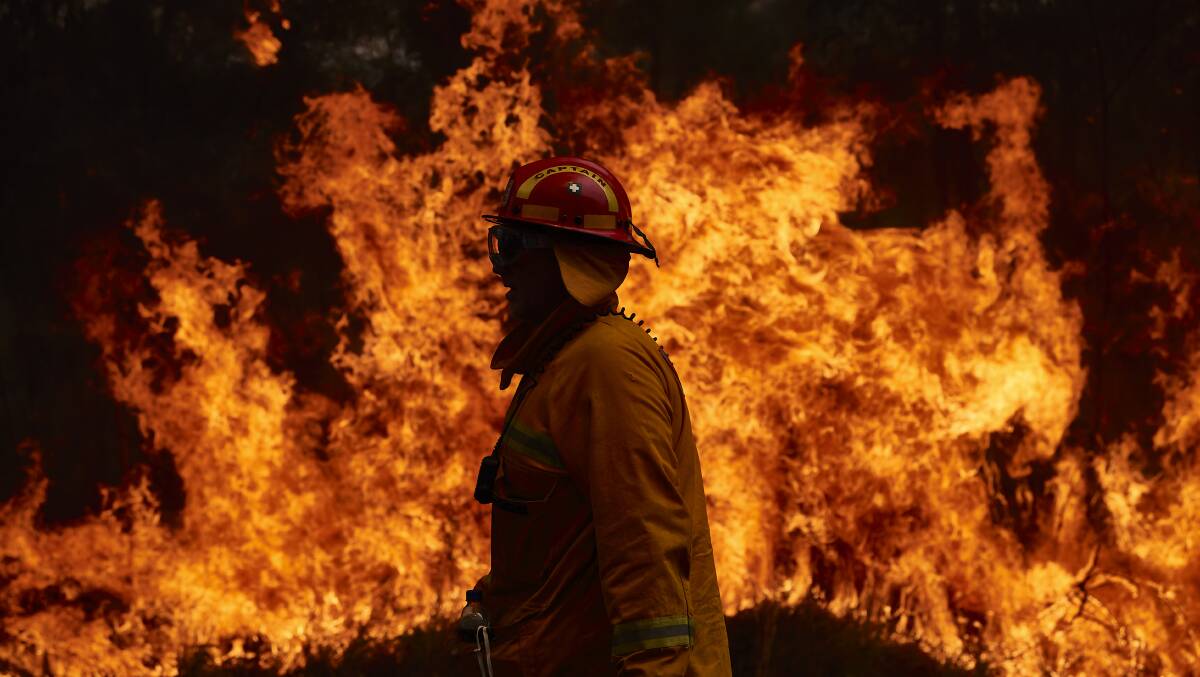 A CFA member works on controlled back burns in Sydney this week. Picture: Getty Images