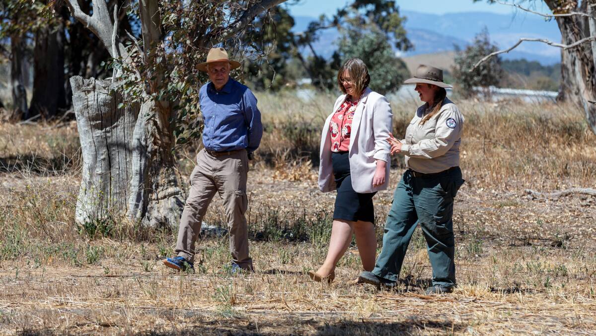 Friends of grasslands president, Geoff Robertson, Member for Yerrabi, Suzanne Orr and ACT Parks and Conservation ecologist, Thea O'Loughlin at the new Franklin Grasslands. Picture: Sagi Biderman