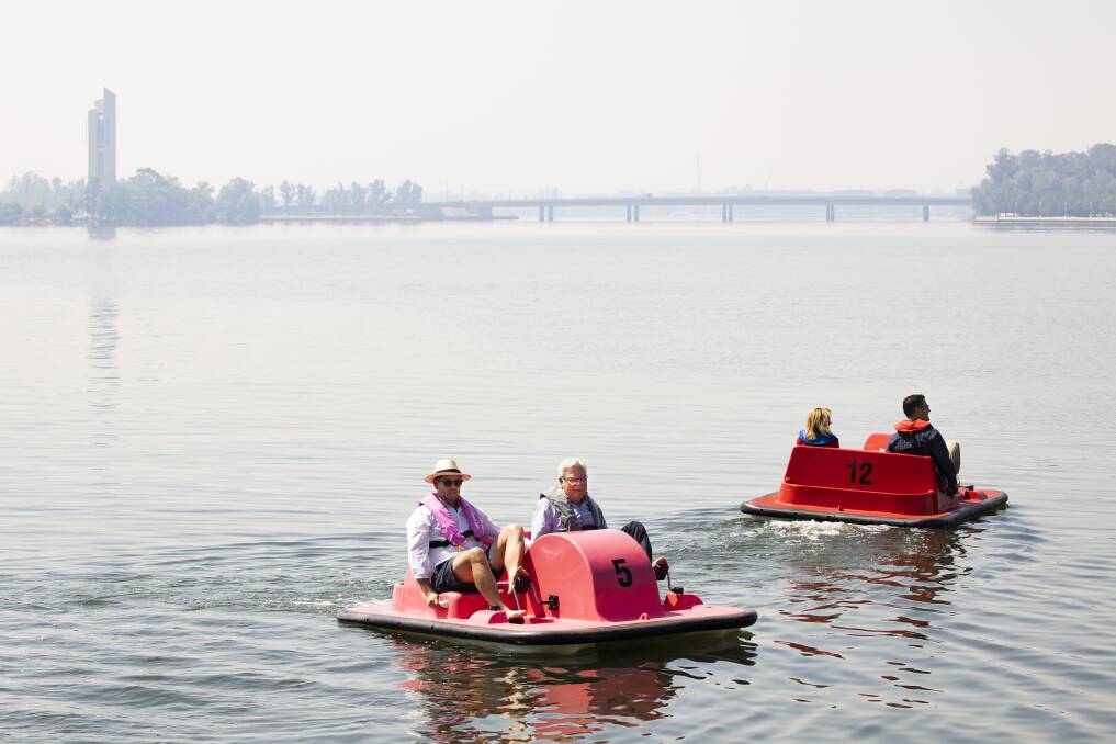 Captain Paddle's Nick Tyrrell, National Capital Authority chair Terry Weber, Assistant Minister for Territories Nola Marino, and ACT Liberal Senator Zed Seselja try out the pedal boats amid bushfire smoke on Friday. Picture: Sitthixay Ditthavong
