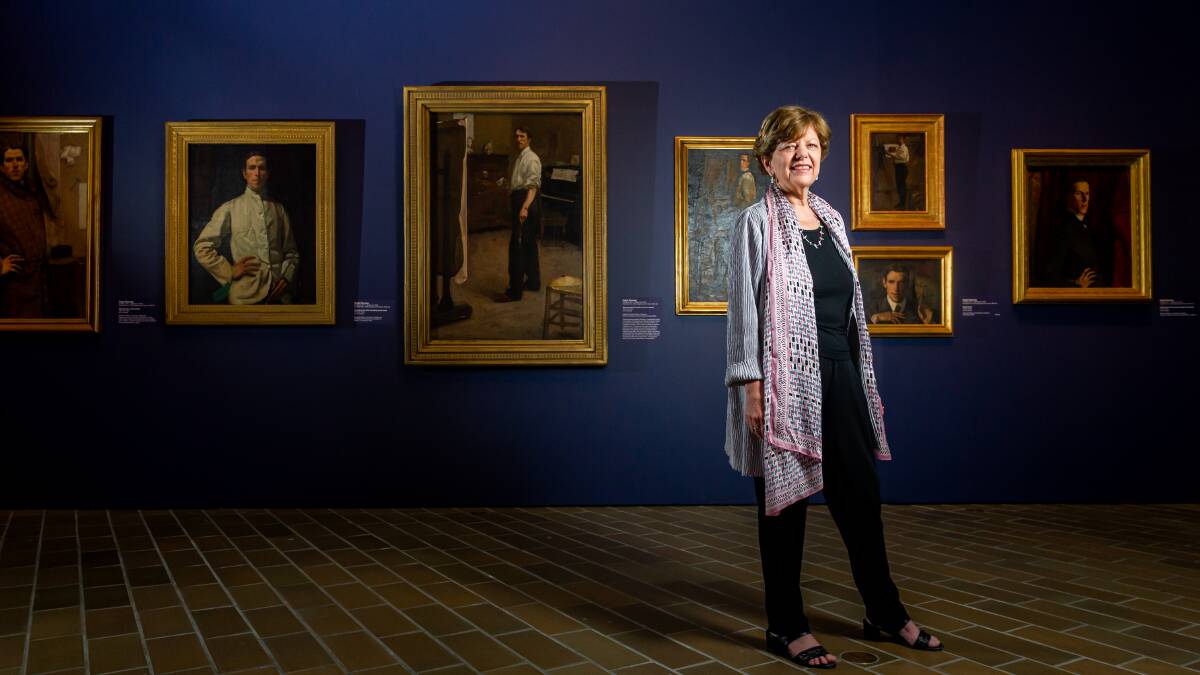 Deborah Hart, head of Australian art at the National Gallery of Australia, in front of a wall of self-portraits by the artist Hugh Ramsay. Picture: Elesa Kurtz