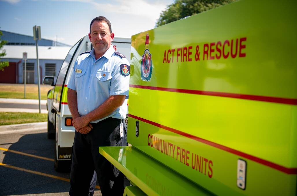 ACT Fire and Rescue community fire unit co-ordinator Tony Wiggan with one of the trailers of firefighting equipment given to volunteers in Canberra. Picture: Elesa Kurtz