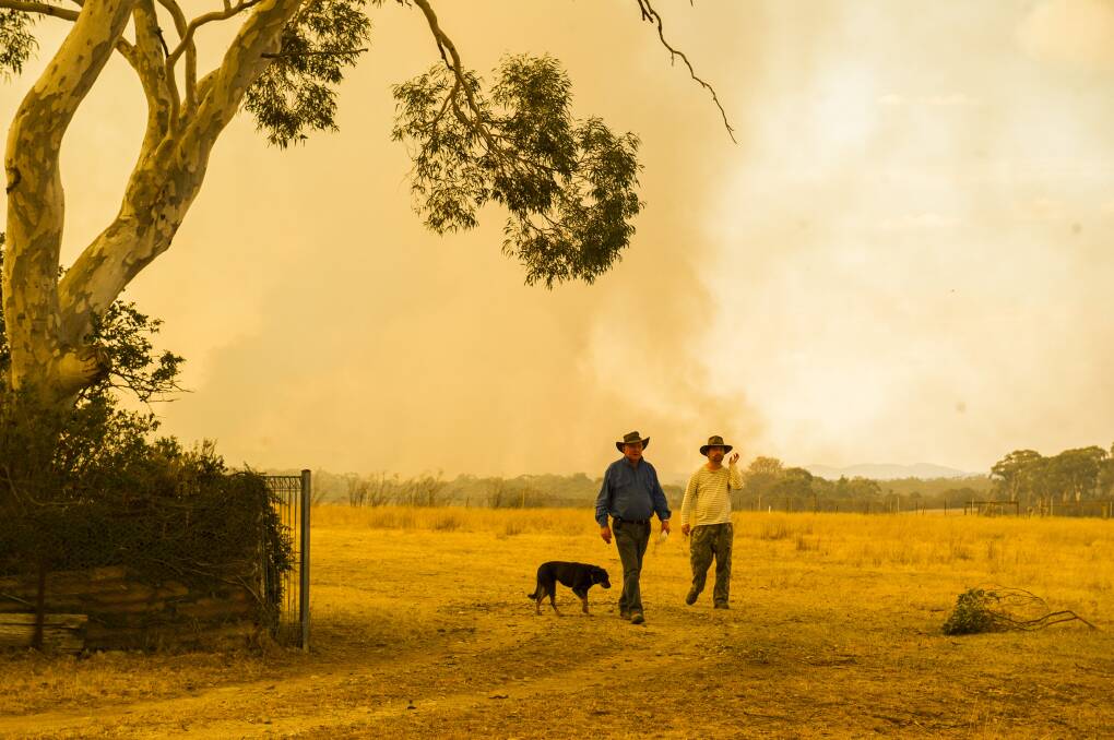 Les and Ben Hart stay to fight the fire on their property in Bombay. Picture: Dion Georgopoulos