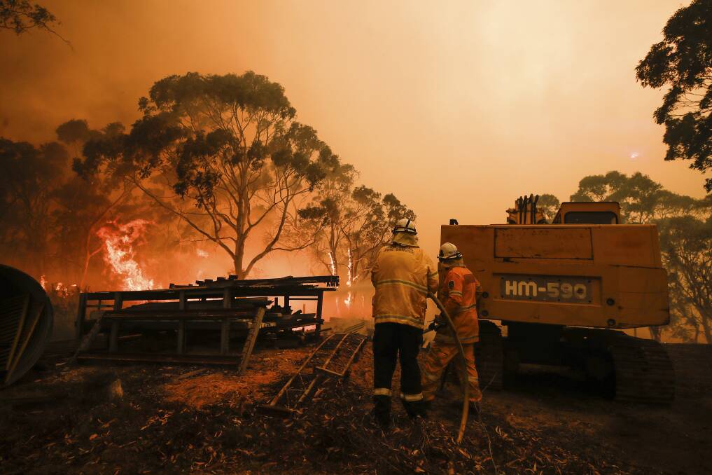 Firefighters work to protect properties as the North Black Range bushfire threatens properties at Bombay. Picture: Alex Ellinghausen