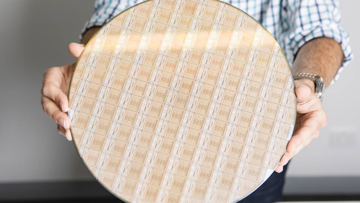 IBM distinguished engineer Anton Blanchard with a wafer that sits inside a Summit supercomputer node. Picture: Jamila Toderas