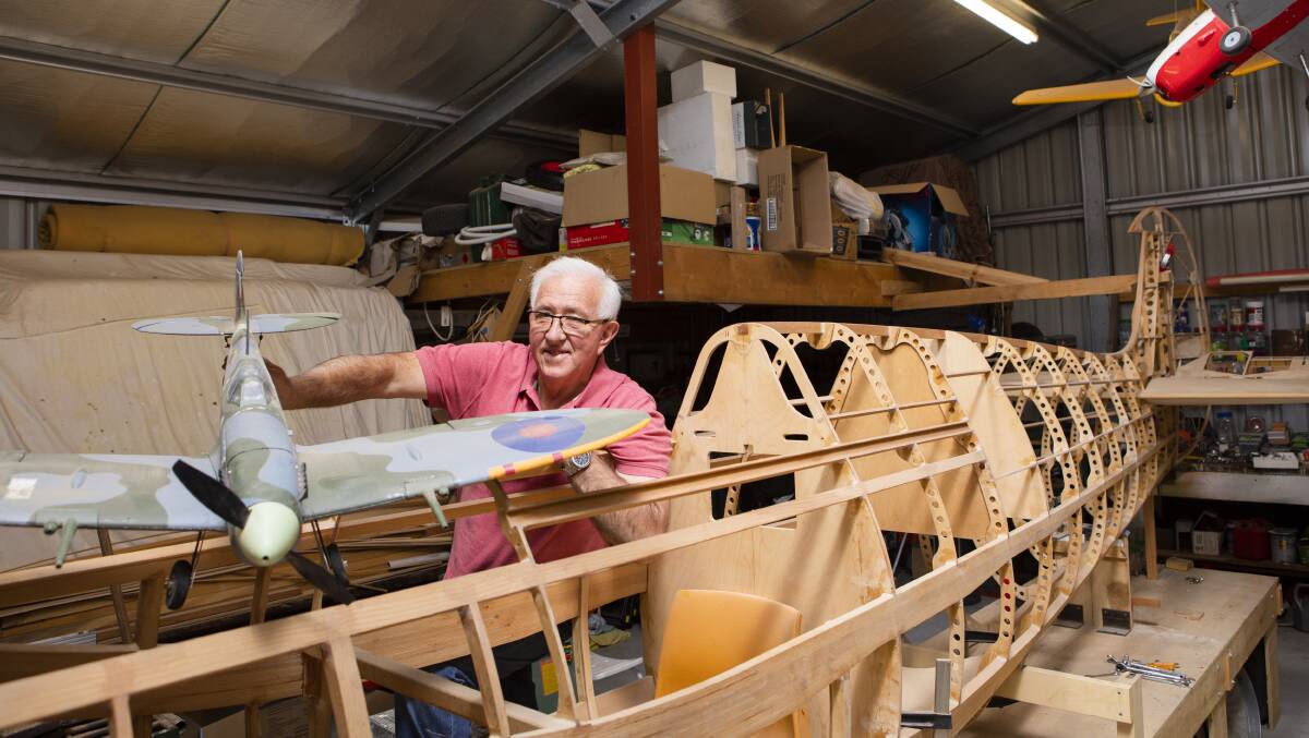 Lawrie Paul with the replica Spitfire aeroplane he is building in his shed. Picture: Jamila Toderas