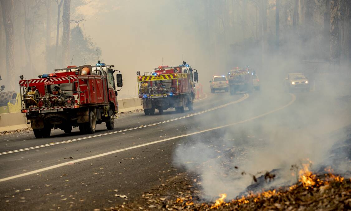 Fire crews head back into the smoke-filled forest on the NSW South Coast. Picture: Sitthixay Ditthavong