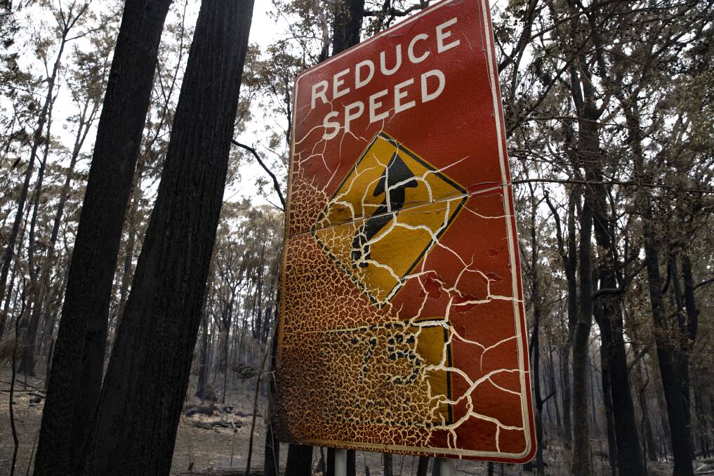 A burnt-out road sign shows the intensity of the Currowan Creek fire. Picture: Sitthixay Ditthavong
