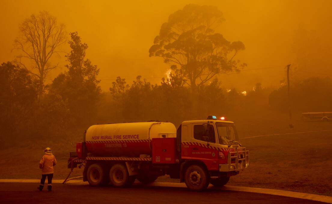 Fire crews battle to save homes on Thrush Street in Bawley Point on Thursday. Picture: Sitthixay Ditthavong
