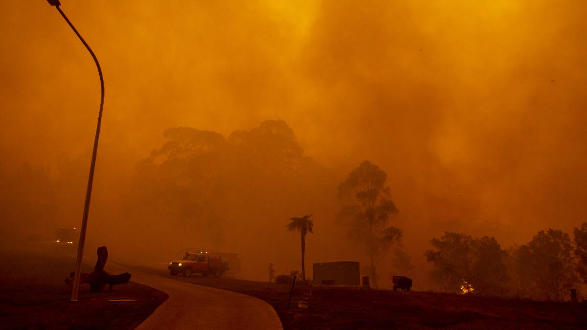 Fire crews battle to save homes on Thrush Street in Bawley Point on Thursday. Picture: Sitthixay Ditthavong