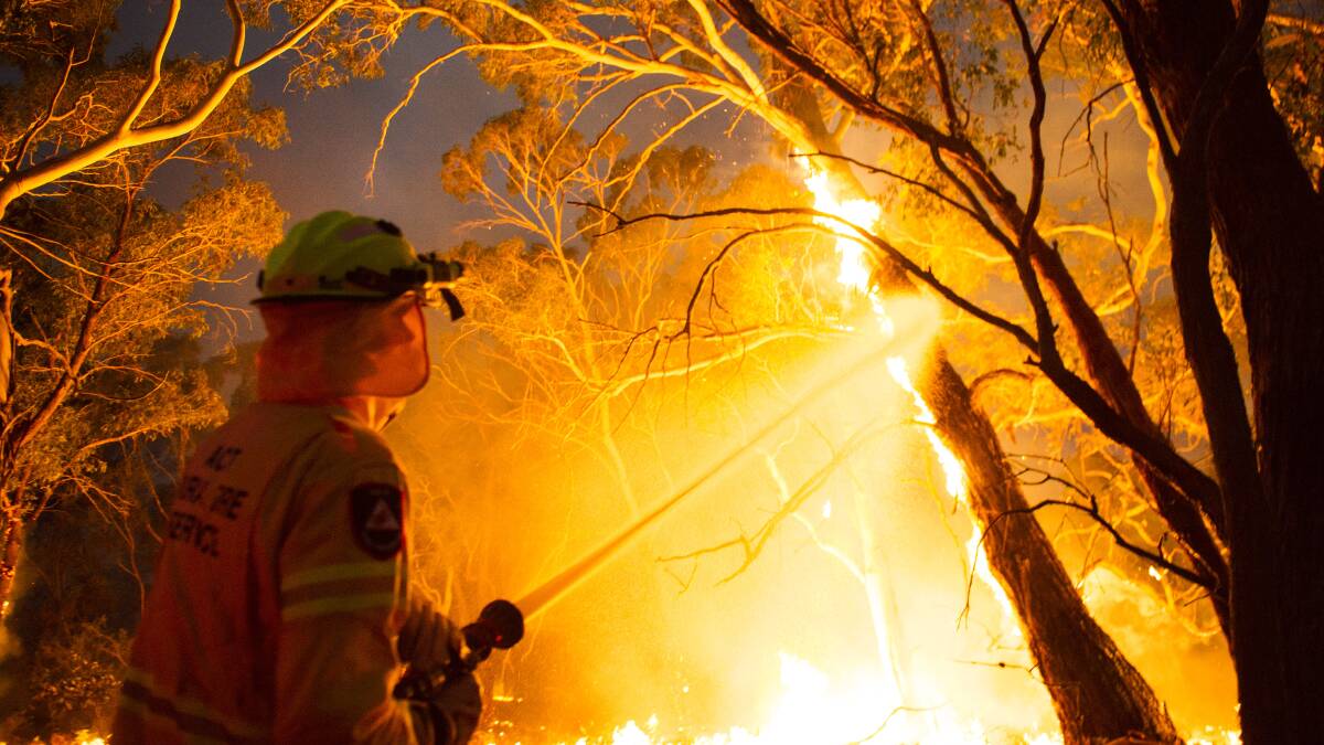 A firefighter in the heat of battle against the North Black Range bushfire on Thursday. Picture: Dion Georgopoulos