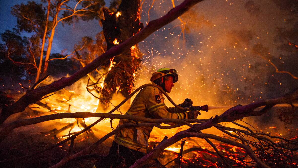 A firefighter in the heat of battle against the North Black Range bushfire on Thursday. Picture: Dion Georgopoulos